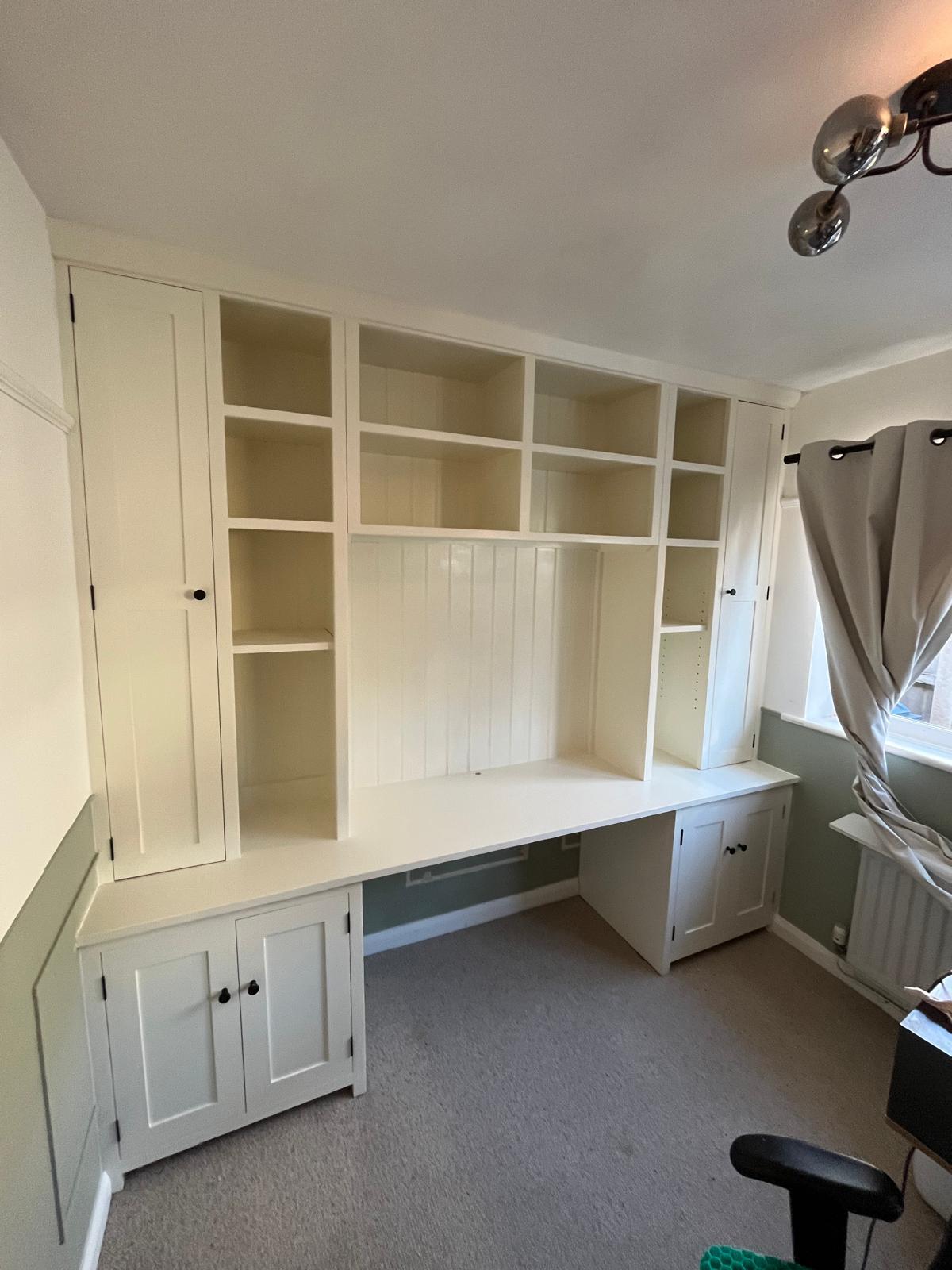 White fitted desk, cupboards and shelving in a home office