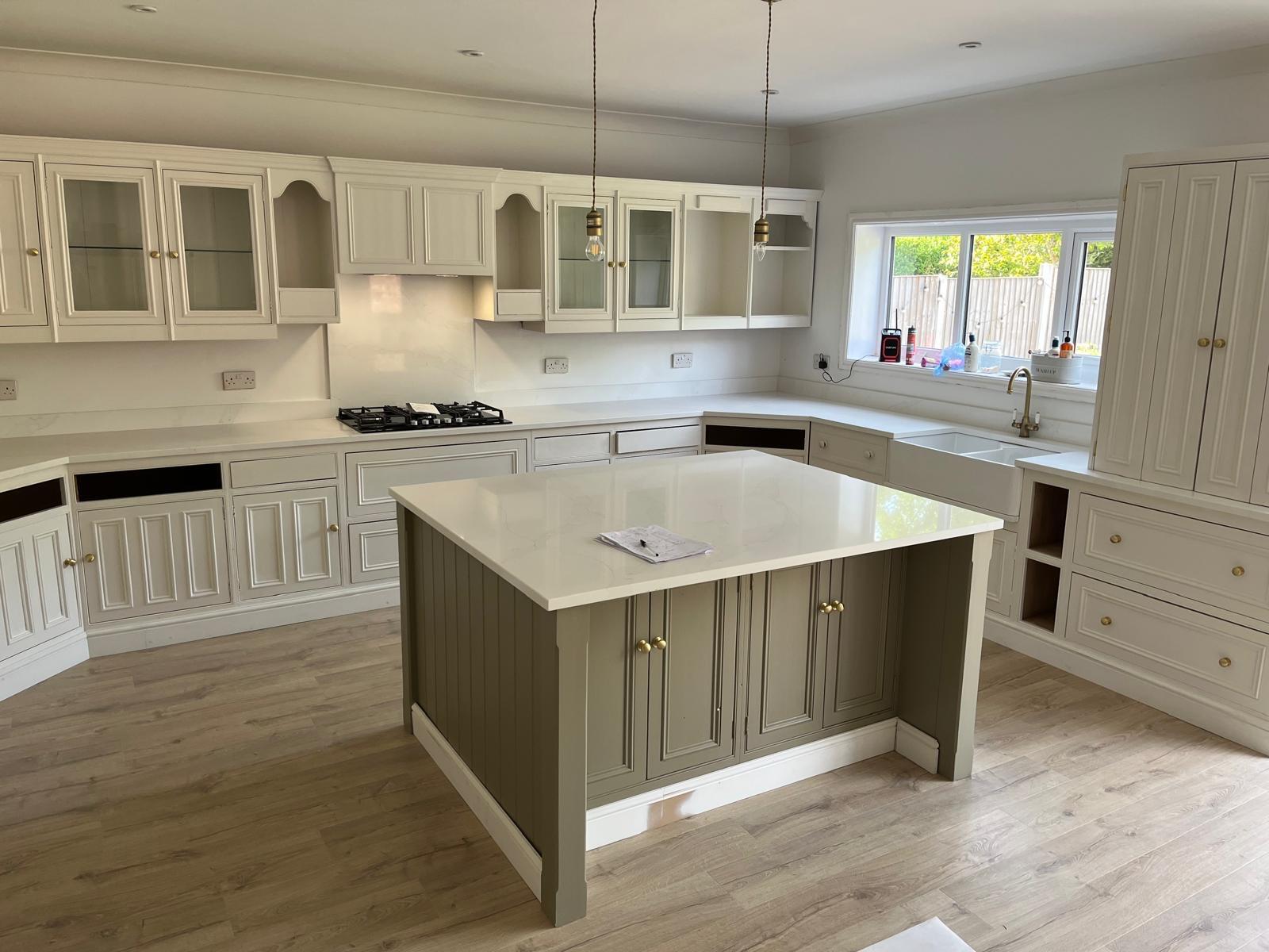 Cream kitchen with a contrasting island and white worktops