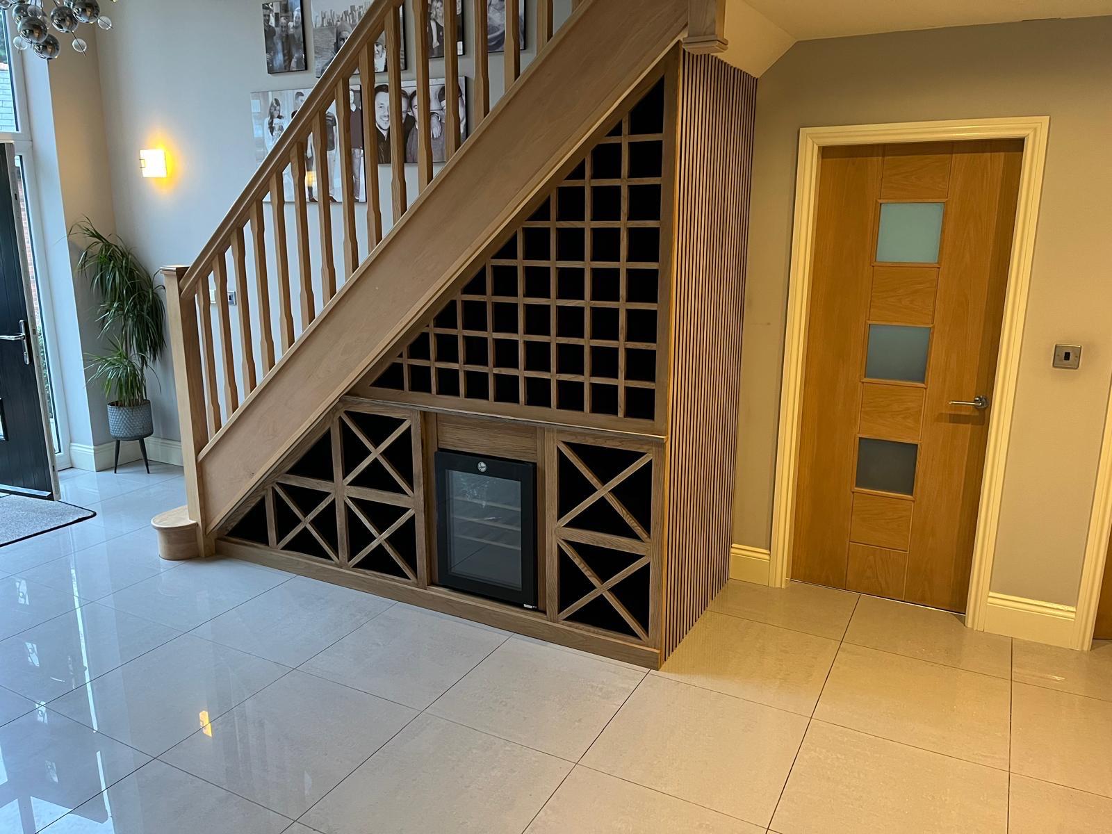 Bespoke under-stairs wine storage with a drinks fridge